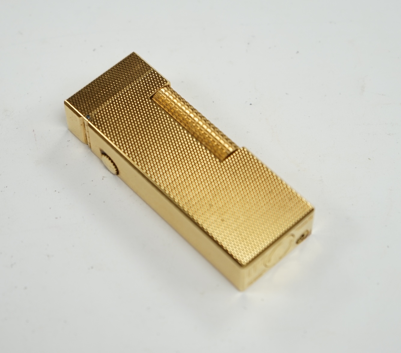 A cased gilt metal Dunhill ‘Rollagas’ lighter, 6.5cm high. Condition - some slight marks to case